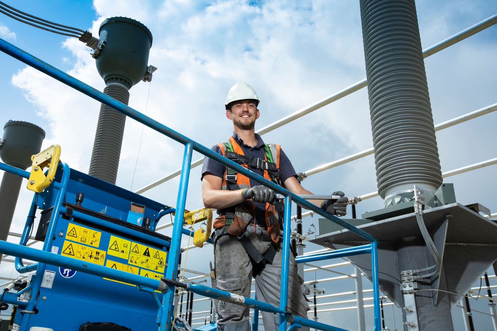 employee on lift working in a substation